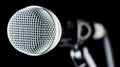 Closeup microphone, macro mic, karaoke, concert, voice music. Closeup microphone. Vocal audio mic on a bleck background