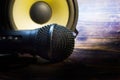 Closeup with microphone and speaker on vintage wooden table Royalty Free Stock Photo