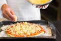 Closeup mid section of a male chef preparing pizza in kitchen Royalty Free Stock Photo