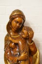 Closeup mid shot of a mother and child wooden sculpture  against a white brick wall Royalty Free Stock Photo