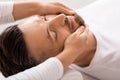 Closeup of man getting healing face massage at spa Royalty Free Stock Photo