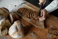 Closeup middle section woman chef cutting yeast-free sourdough bread