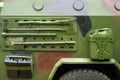 Closeup military armored vehicle with attached tool.