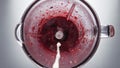 Closeup milk pouring blender with berry blend in super slow motion top view. Royalty Free Stock Photo