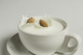 Closeup milk splash with almonds nut on white background