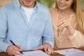 Close up of millennial couple with key to their new house signing tenancy agreement Royalty Free Stock Photo