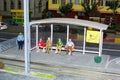 Closeup of mini-figures of people sitting at a bus stop. Museum of miniatures in Wroclaw, Poland.