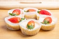 Closeup of the mini strawberry cheesecakes on the wooden table