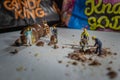 Closeup of miniature construction workers making chocolate balls Royalty Free Stock Photo