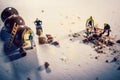 Closeup of miniature construction workers making chocolate balls Royalty Free Stock Photo