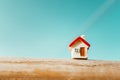 Closeup miniature house on blue sky background using as property