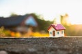 Closeup miniature house on sunset background using as property a