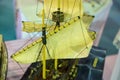 Closeup of a miniature ship with yellow sails Royalty Free Stock Photo