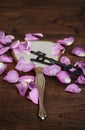 Closeup mirror with pink rose petals and a key