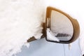 closeup mirror Snow on cars after snowfall. Winter urban scene with sun flare Royalty Free Stock Photo