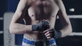 Closeup of a mixed martial arts fighter wrapping his hands before a fight. Boxer wraps his hand a red bandage before the Royalty Free Stock Photo