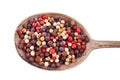 Closeup mixed peppercorns in silver rustic spoon. Isolated on white background with work path.