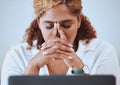 Closeup of a mixed race businesswoman suffering from a headache working on a laptop alone at work. Hispanic woman Royalty Free Stock Photo