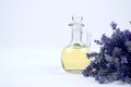 Closeup mockup image of glass bottle with lavender essential oil and lavender flowers on white background with copyspace for text Royalty Free Stock Photo