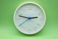 modern analog clock on green background