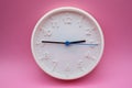 modern analog clock on pink background