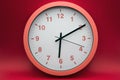 modern analog clock on red background