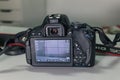 Closeup of modern black DSLR camera on white table Royalty Free Stock Photo