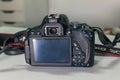 Closeup of modern black DSLR camera on white table Royalty Free Stock Photo