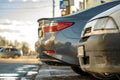 Closeup of a modern cars parked on a side of a city street on a sunny day Royalty Free Stock Photo