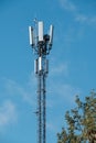 Closeup of a modern communications tower with bright blue sky in the background Royalty Free Stock Photo