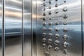 Closeup of a modern elevator control panel with brushed metal buttons and reflective surfaces Royalty Free Stock Photo