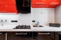 Closeup of modern kitchen interior in white and black tones with, stove and extractor closeup. Cozy place for cooking Royalty Free Stock Photo