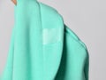 Closeup of modern mint color hood seamy side, cowl top fabric with blank transparent label ready to copy paste
