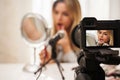 Modern mirrorless camera recording video of beauty blogger& x27;s make-up routine