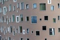 Closeup of a modern residential building with windows of different shapes at daylight