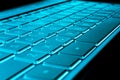 Closeup of a modern silver laptop computer keyboard. Laptop keyboard. Detail of the new and ergonomic computer keyboard. Blue tone Royalty Free Stock Photo