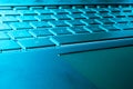 Closeup of a modern silver laptop computer keyboard. Laptop keyboard. Detail of the new and ergonomic computer keyboard. Blue tone Royalty Free Stock Photo