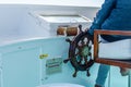 Closeup of the modern yacht steering wheel and captain hand