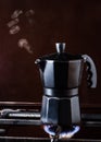 Closeup of Moka coffee pot on a gas stove Boils and lets off steam