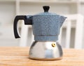 Closeup of moka pot standing on wooden table