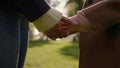 Closeup mom hands joining daughter in autumn park. Loving parent caress support Royalty Free Stock Photo