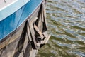 Closeup of mooring anchor on side of cargo ship