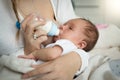 Closeup of mother feeding newborn baby from bottle Royalty Free Stock Photo