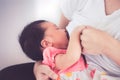 Closeup on mother hand holding baby hand while mother breastfeed