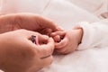 Closeup mother hand holding nail clipper cutting newborn baby nails on tiny fingers while adorable infant sleeping, keep clean Royalty Free Stock Photo