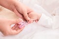 Closeup mother hand holding nail clipper cutting newborn baby nails on tiny fingers while adorable infant sleeping, keep clean Royalty Free Stock Photo