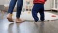 Closeup of mother with little baby boy walking on soft carpet in living room. Baby development, child playing games, education and Royalty Free Stock Photo