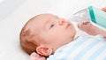 Closeup of mother using electric nasal aspirator to remove mucus from her newborn baby nose. Concept of babies and Royalty Free Stock Photo