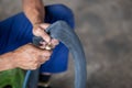 Closeup A motorbike mechanic's hand is inflating a tire. The inner tube of the motorbike that has leaked Checking . Royalty Free Stock Photo