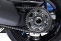 closeup motorcycle chain gear rear wheel for big bike high speed performance clean new